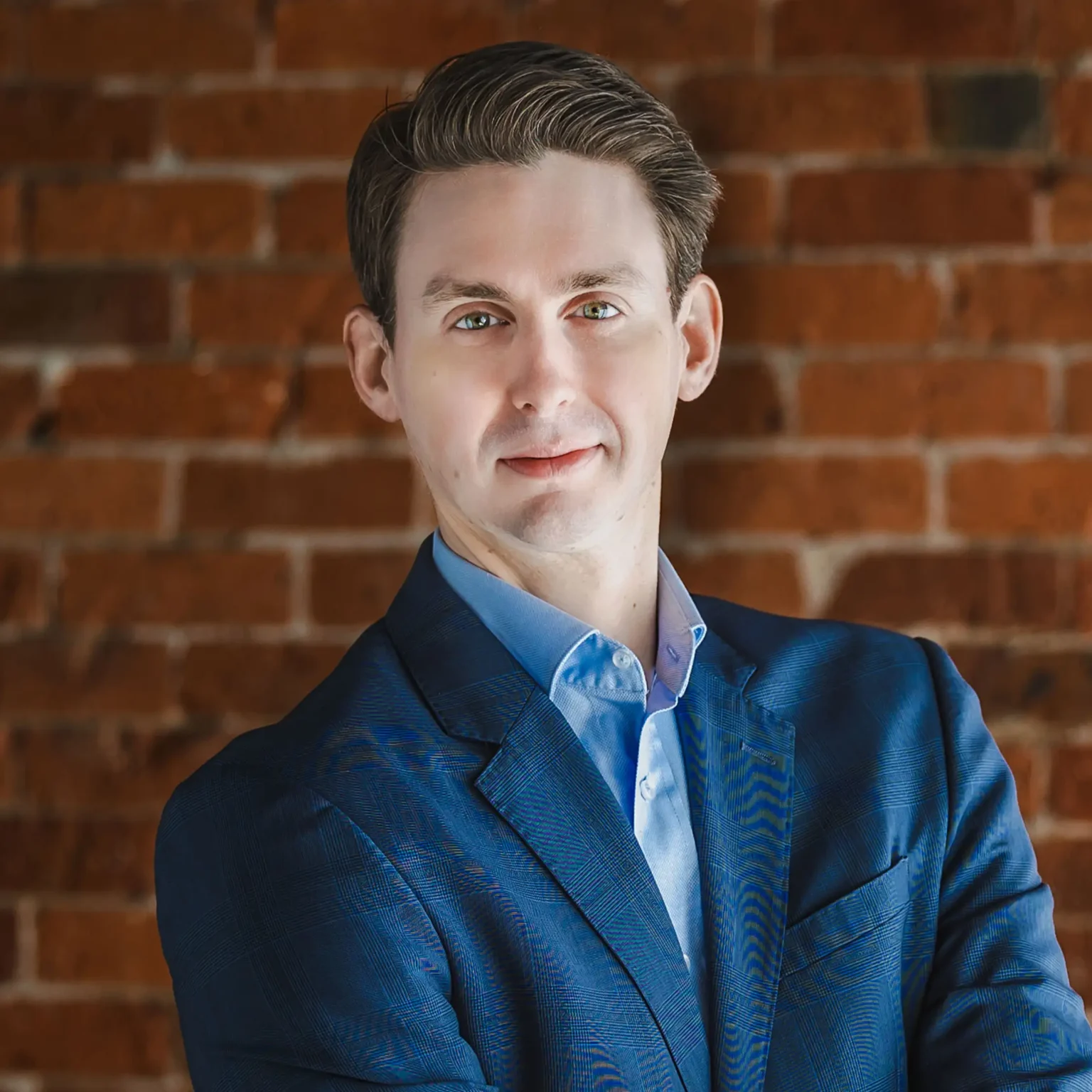 Professional portrait of man against brick wall