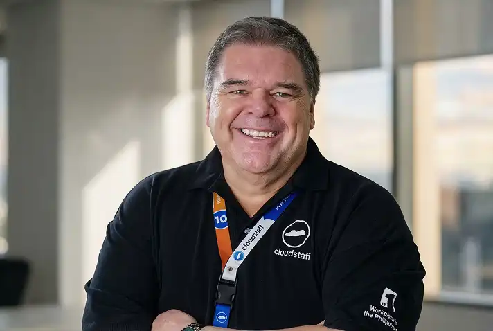 Smiling man in Cloudstaff polo in office