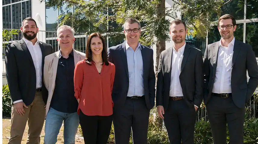 Six business professionals standing outdoors in front of building