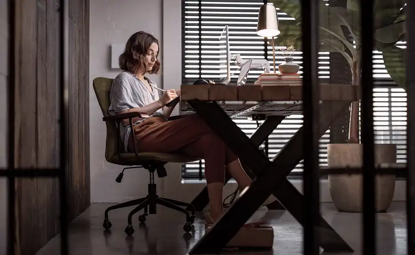 Woman writing at desk in modern home office