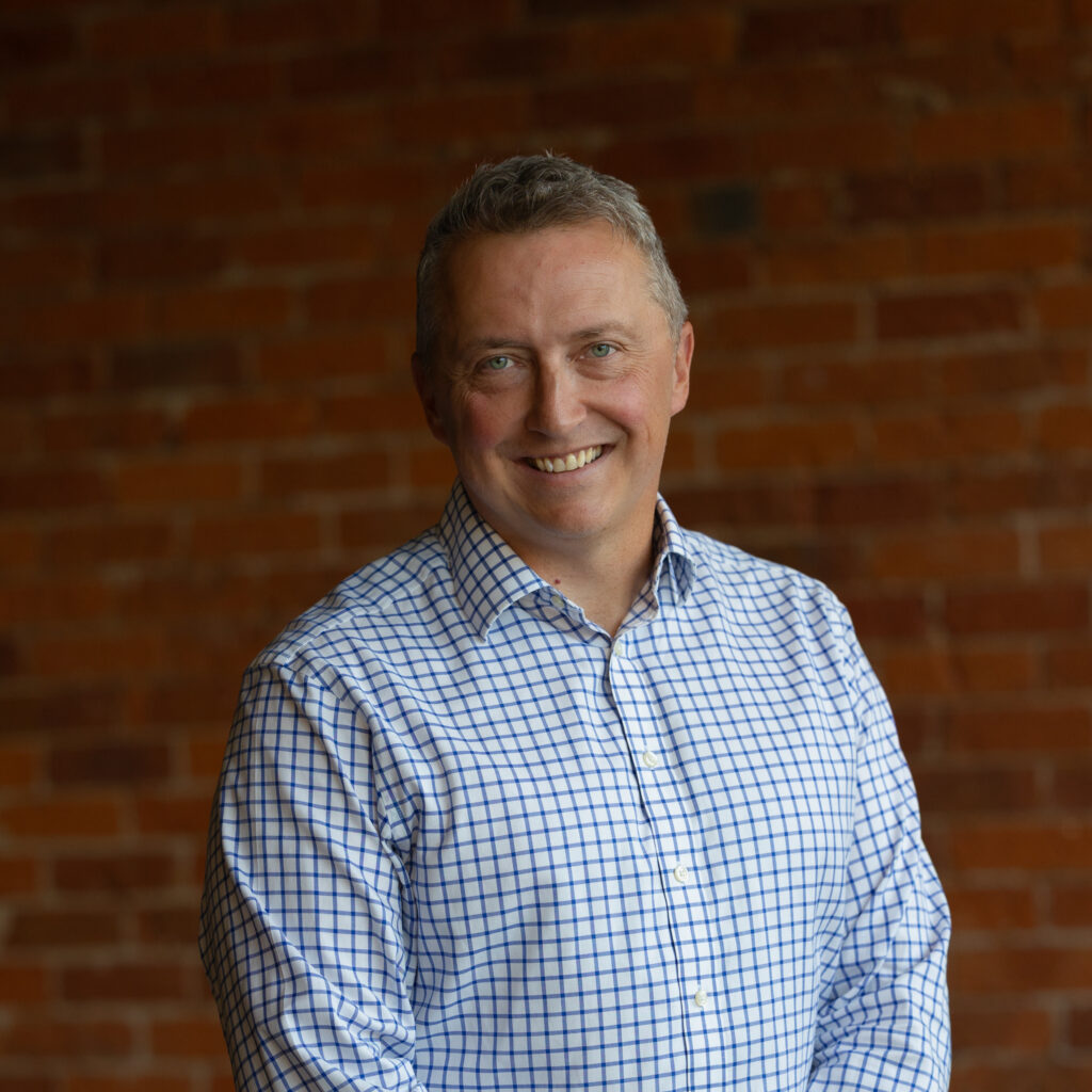 Professional portrait of man against brick wall
